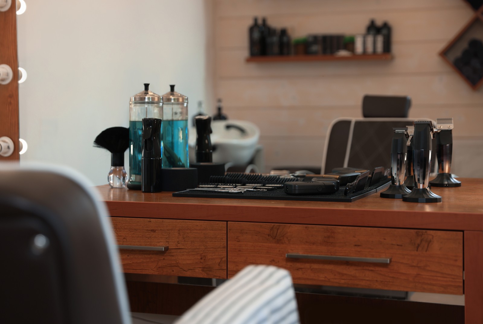 Photo of stylish hairdresser's workplace with professional tools and cosmetic products in barbershop