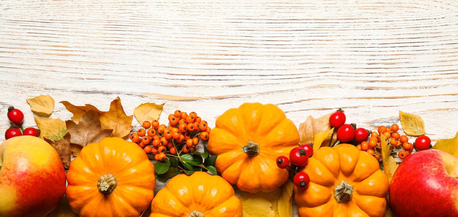 Photo of Happy Thanksgiving day, banner design. Flat lay composition with ripe pumpkins and autumn leaves on white wooden table, space for text