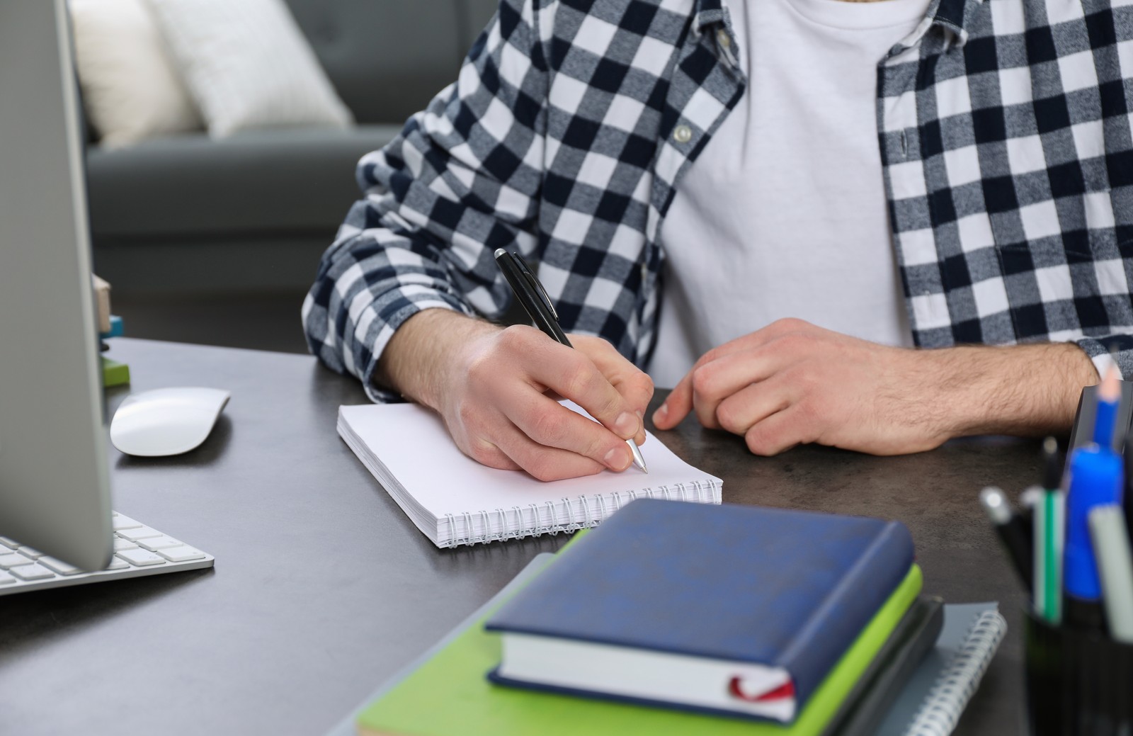 Photo of young man using modern computer for studying at home, closeup. Distance learning