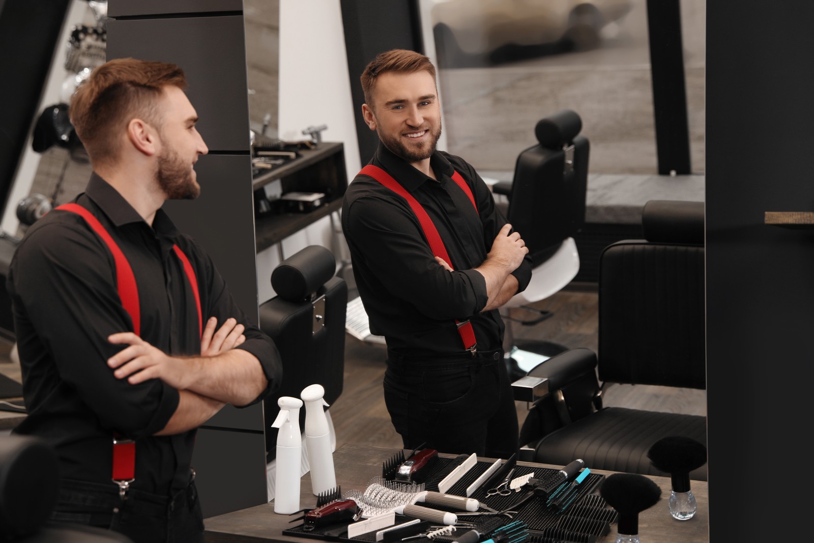 Photo of young business owner in his barber shop
