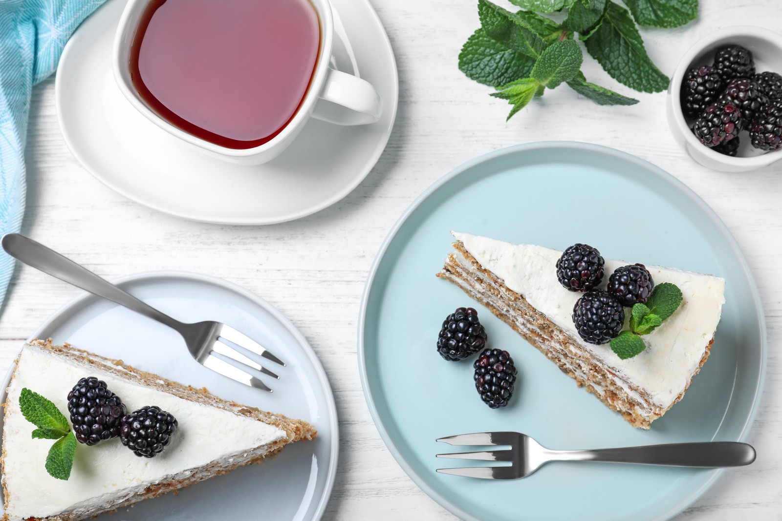 Photo of tasty cake with berries on white wooden table, flat lay