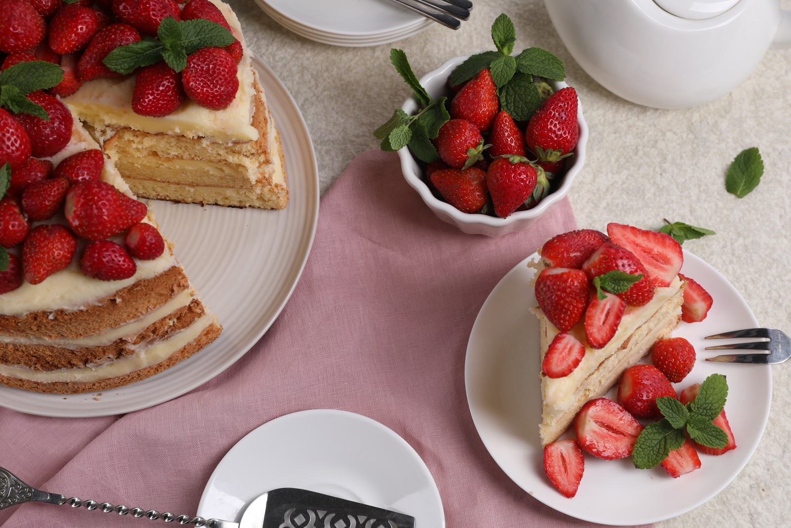 Photo of tasty cake with fresh strawberries and mint on white table, above view