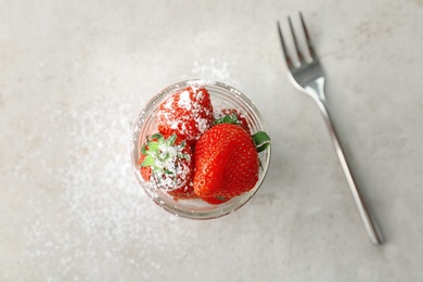Photo of Glass jar with ripe red strawberries on light background, top view
