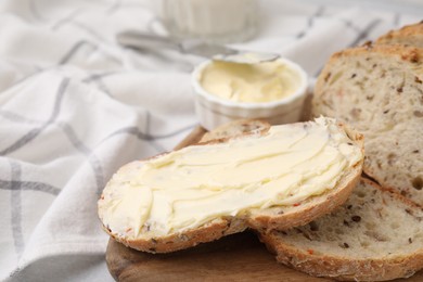 Photo of Tasty bread with butter on table, closeup