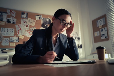 Photo of Detective working at desk in her office