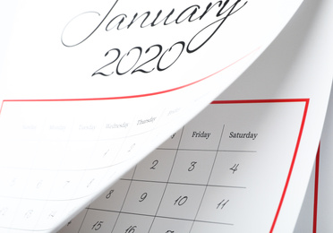 Photo of January 2020 calendar with turning pages as background, closeup