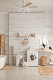 Photo of Stylish bathroom interior with modern washing machine