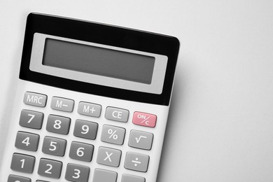Photo of Calculator on light gray background, top view. Space for text
