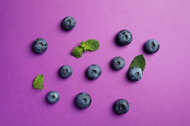 Photo of Flat lay composition with tasty blueberry on color background