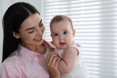 Young mother with her little baby at home