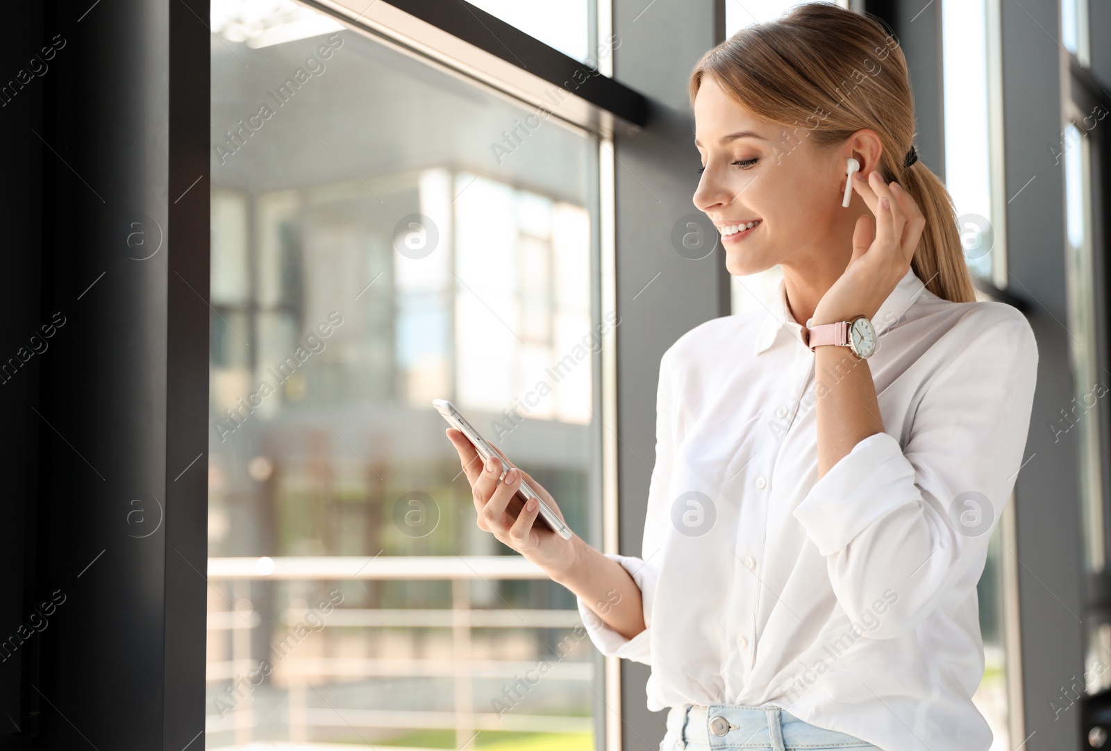 Photo of Portrait of female business trainer with smartphone indoors