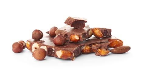 Photo of Delicious milk chocolate with nuts on white background