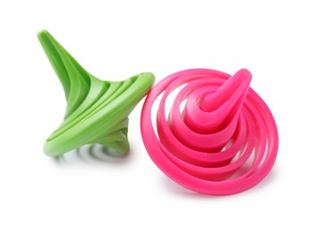 Photo of Green and pink spinning tops isolated on white