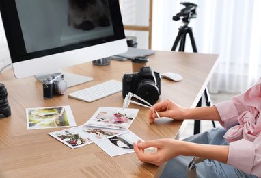 Professional photographer working at table in office, closeup