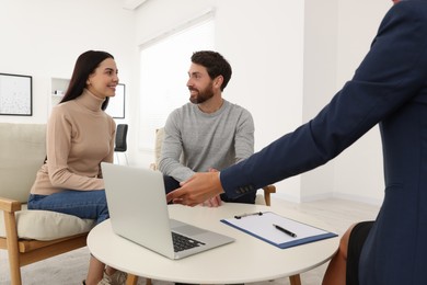 Photo of Real estate agent consulting couple in office