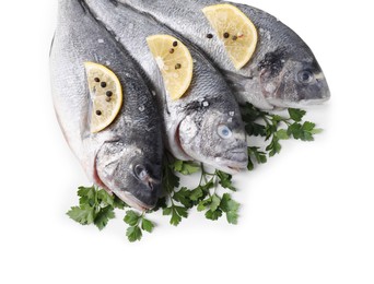 Photo of Raw dorado fish, parsley, lemon slices and peppercorns isolated on white, top view