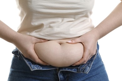 Photo of Woman touching belly fat on white background, closeup. Overweight problem