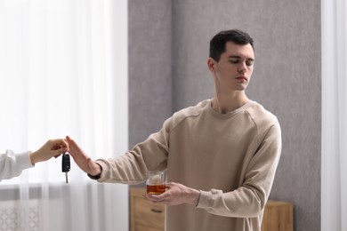 Photo of Drunk man refusing drive car while woman suggesting him keys, closeup. Don't drink and drive concept