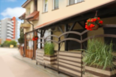 Photo of Blurred view of outdoor cafe decorated with beautiful plants