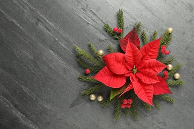 Photo of Flat lay composition with beautiful poinsettia on grey background, space for text. Christmas traditional flower
