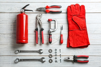 Photo of Flat lay composition with construction tools on wooden background