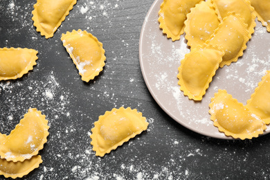 Photo of Ravioli on grey wooden table, flat lay. Italian pasta