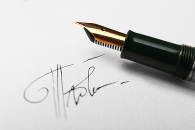 Photo of Sheet of paper with fountain pen and signature, closeup