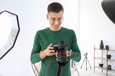 Photo of Young photographer working in professional studio