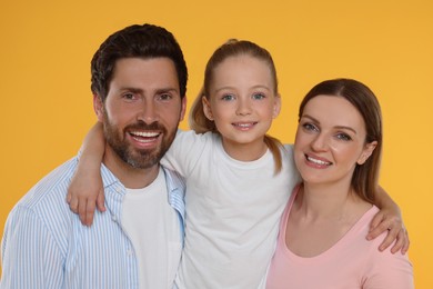 Photo of Portraithappy family on orange background