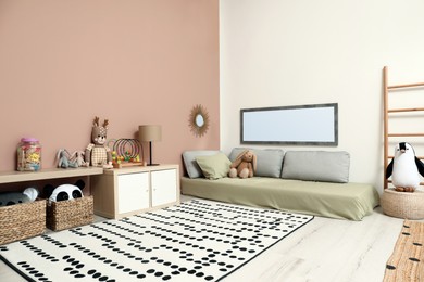 Photo of Montessori bedroom interior with floor bed and toys