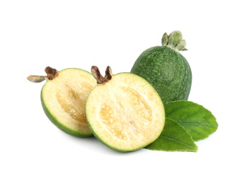 Photo of Cut and whole feijoas with leaves on white background