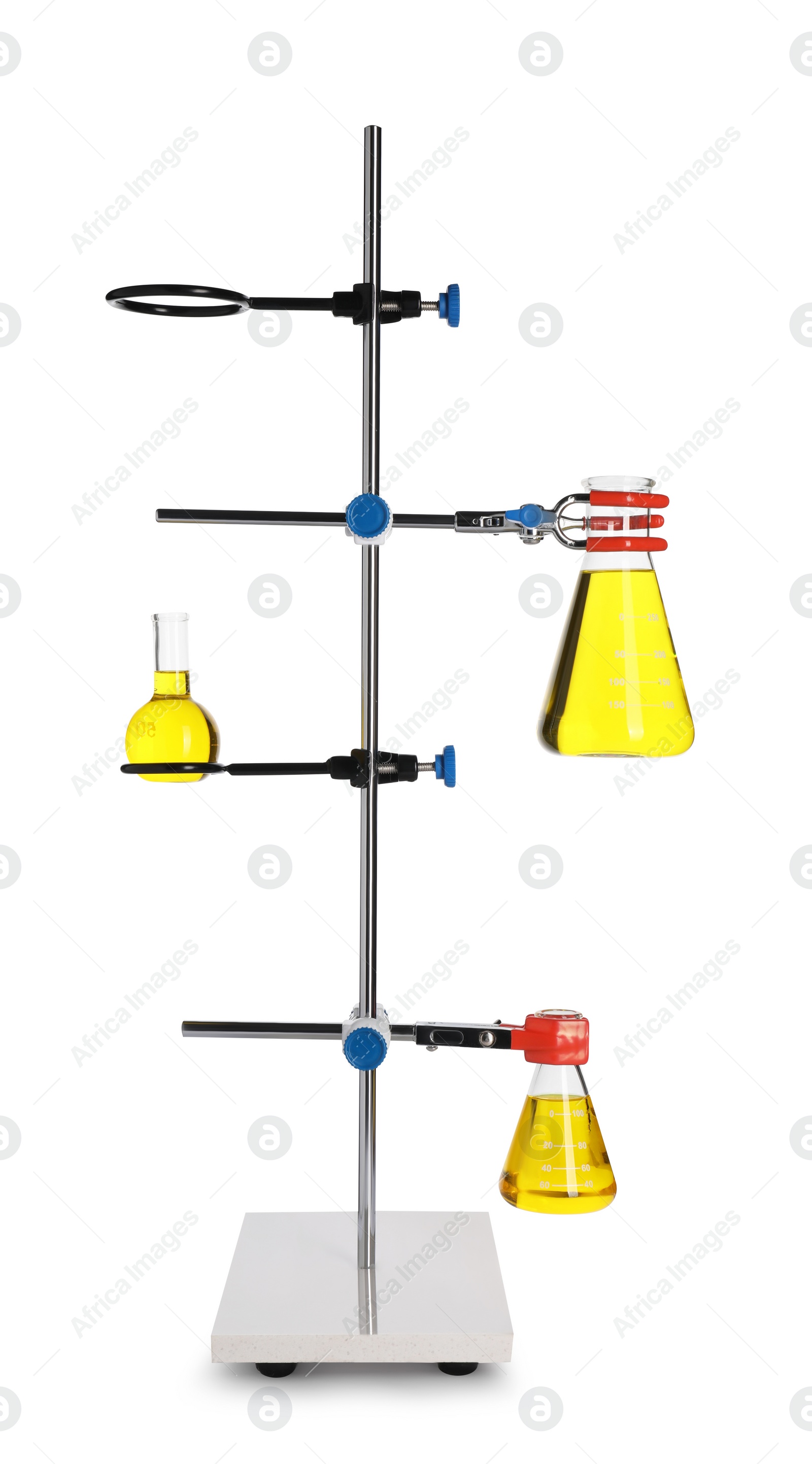 Photo of Retort stand with flasks of yellow liquid isolated on white