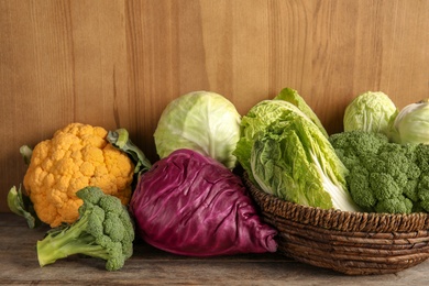 Photo of Different fresh cabbages on table. Healthy food