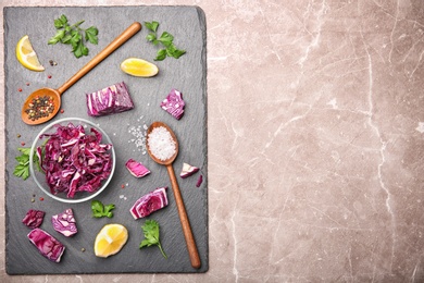 Photo of Slate plate with chopped red cabbage and different ingredients, top view
