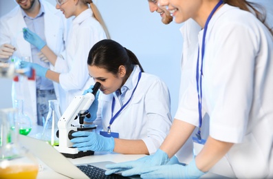 Photo of Group of scientists working in modern chemistry laboratory