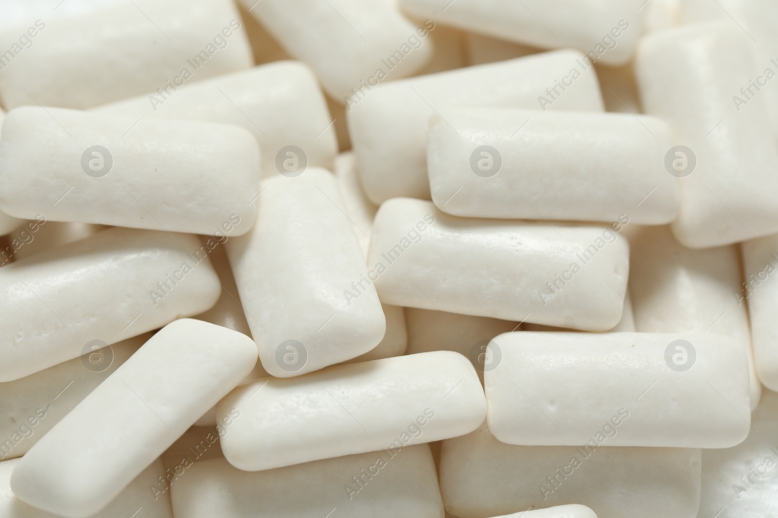 Photo of Tasty white chewing gums as background, closeup