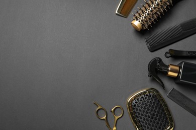 Photo of Hairdressing tools on dark table, flat lay. Space for text