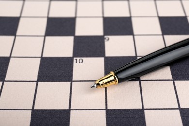 Photo of Pen on blank crossword, closeup. Space for text