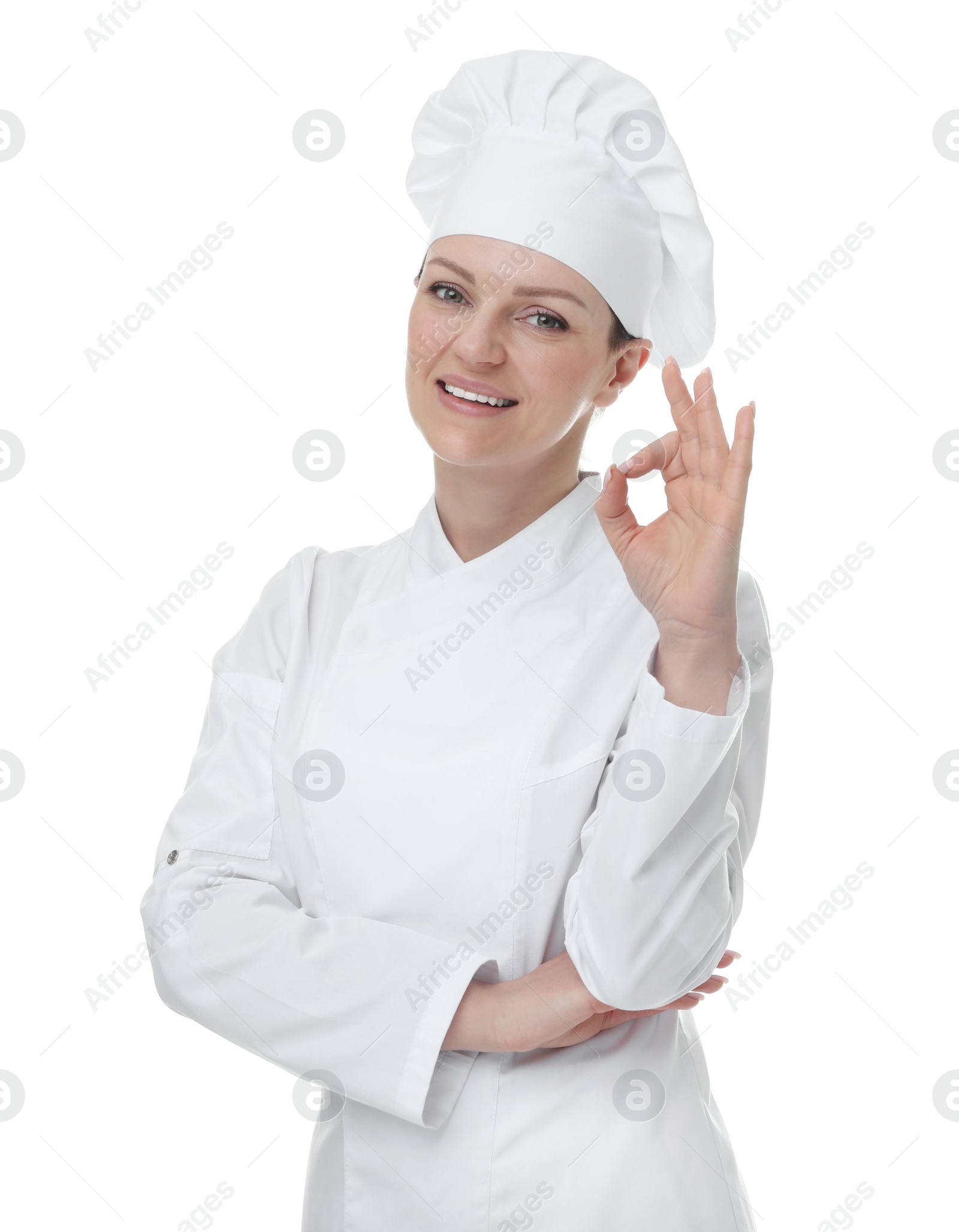 Photo of Happy woman chef in uniform showing OK gesture on white background