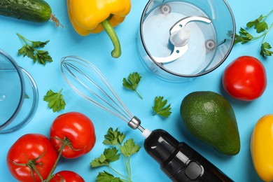 Photo of Hand blender kit and fresh products on light blue background, flat lay