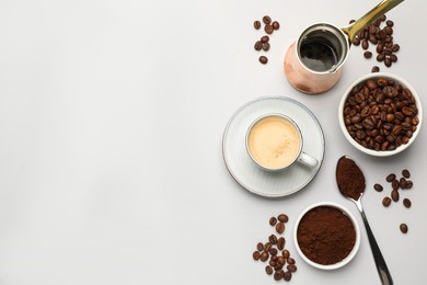 Photo of Flat lay composition with coffee grounds and roasted beans on white background, space for text