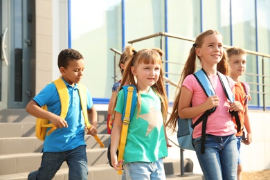 Cute little children with backpacks outdoors. Elementary school