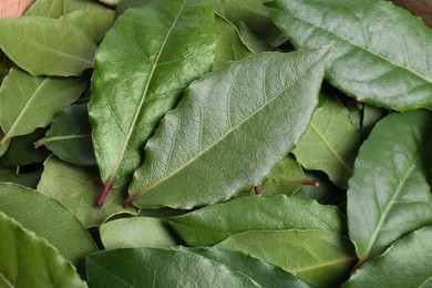 Photo of Many fresh bay leaves, flat lay. Spices for cooking