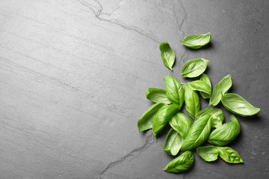 Photo of Fresh basil on grey table, flat lay. Space for text