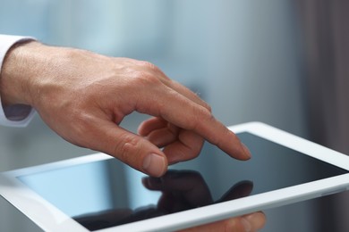 Photo of Closeup view of man using new tablet indoors