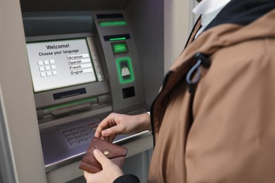Man entering cash machine pin code, closeup