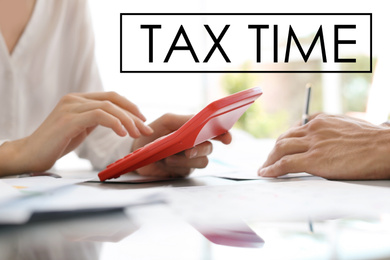 Image of Tax accountants working with documents at table, closeup