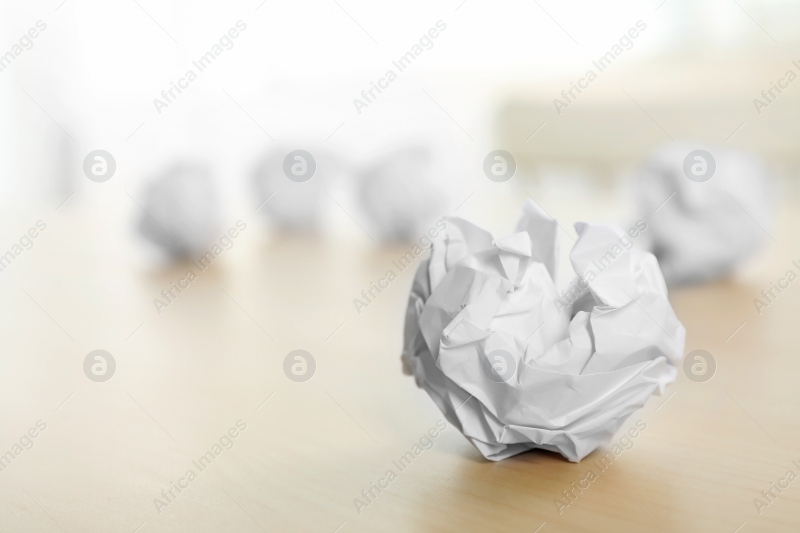 Photo of Sheet of crumpled paper on wooden table, space for text