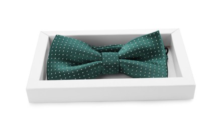 Photo of Stylish green bow tie with polka dot pattern on white background