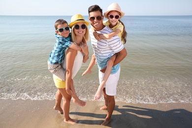 Photo of Happy family at beach on sunny summer day